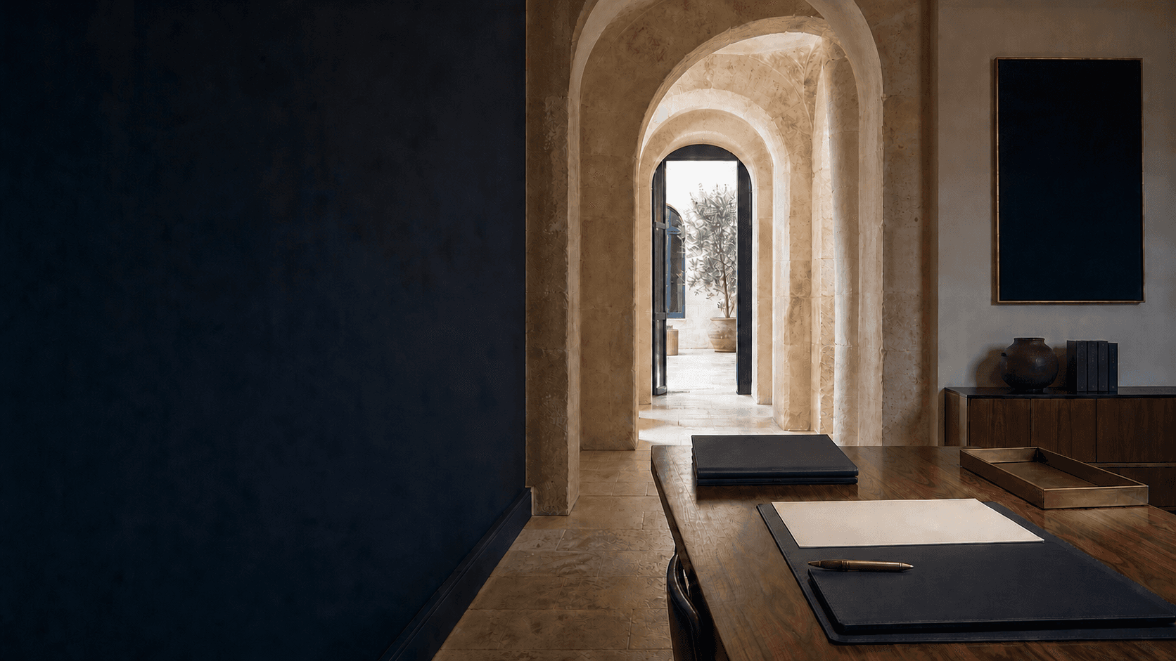 Unoccupied Malta legal office with blank case folios beside a sequence of limestone arches