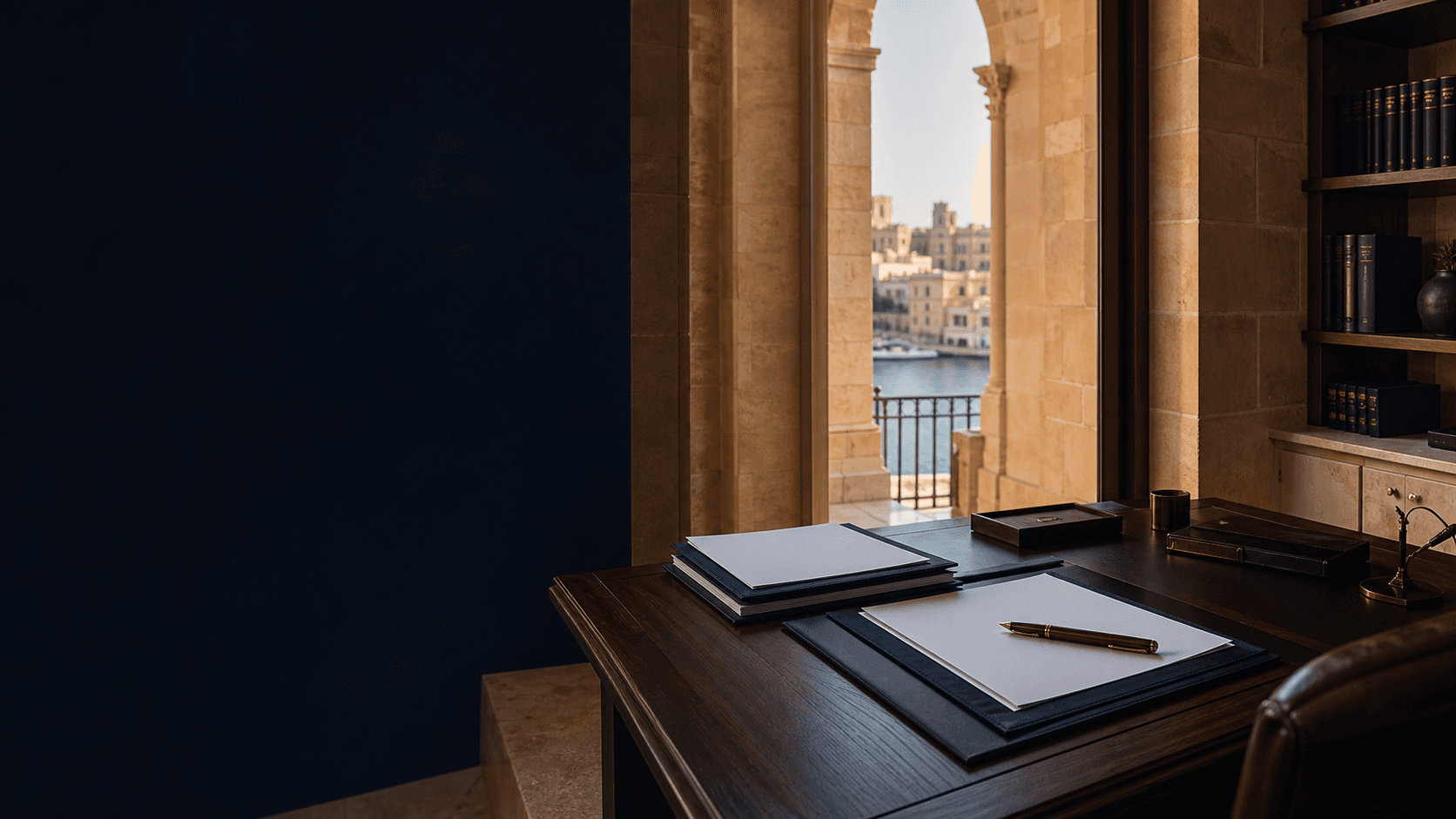 Unoccupied Malta legal office with blank commercial agreement papers, navy folders and limestone arches