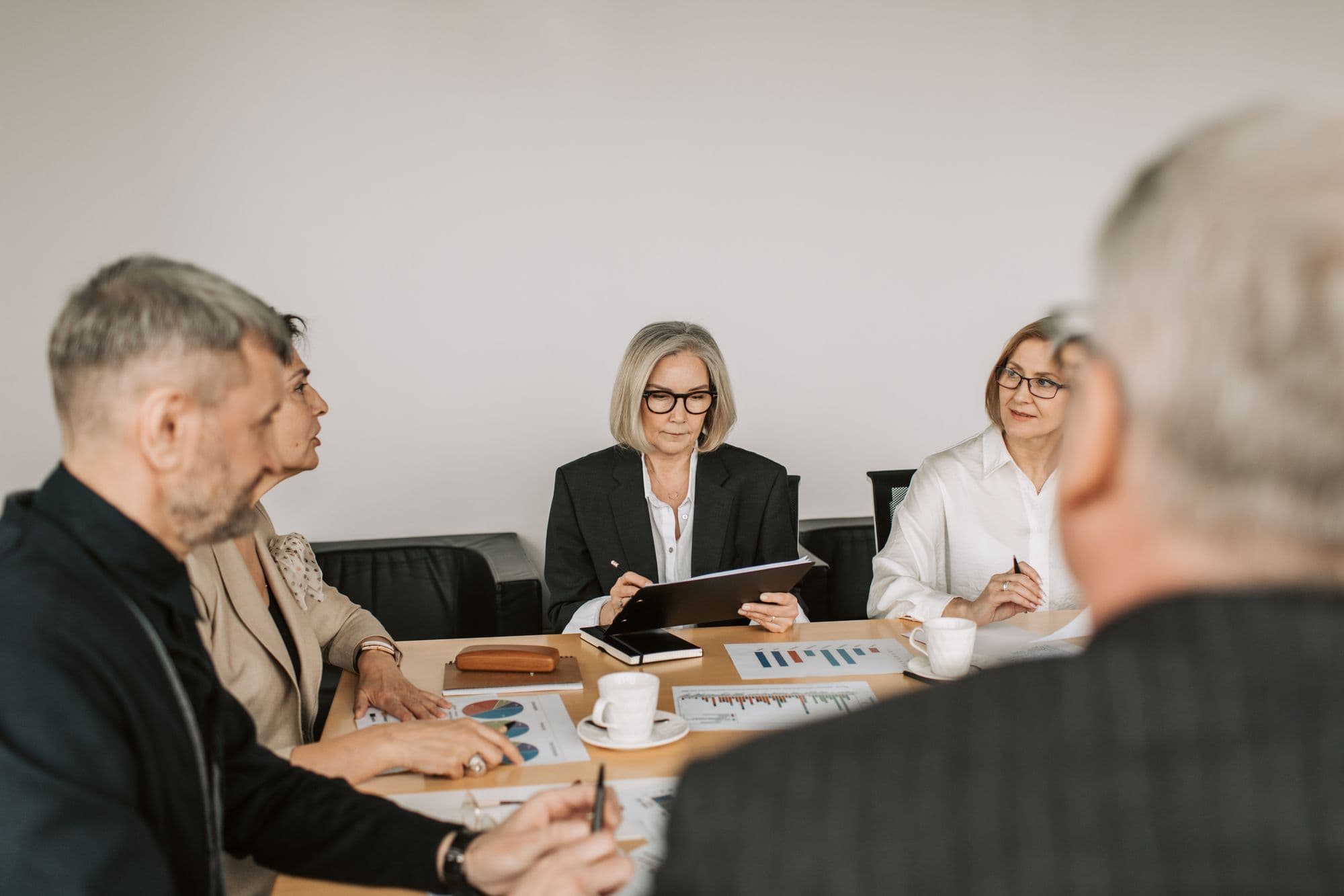 Illustrative stock photograph of advisers reviewing figures together