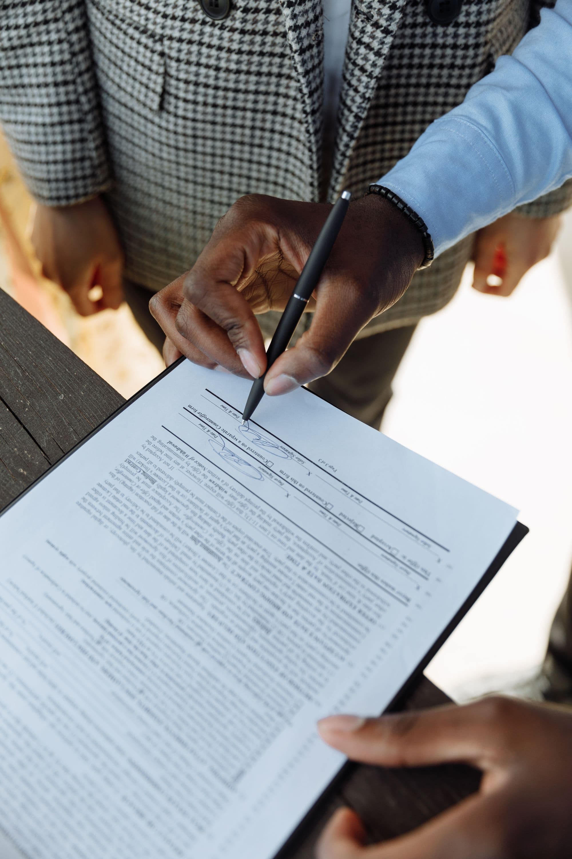 Close-up stock photograph of a person signing an agreement