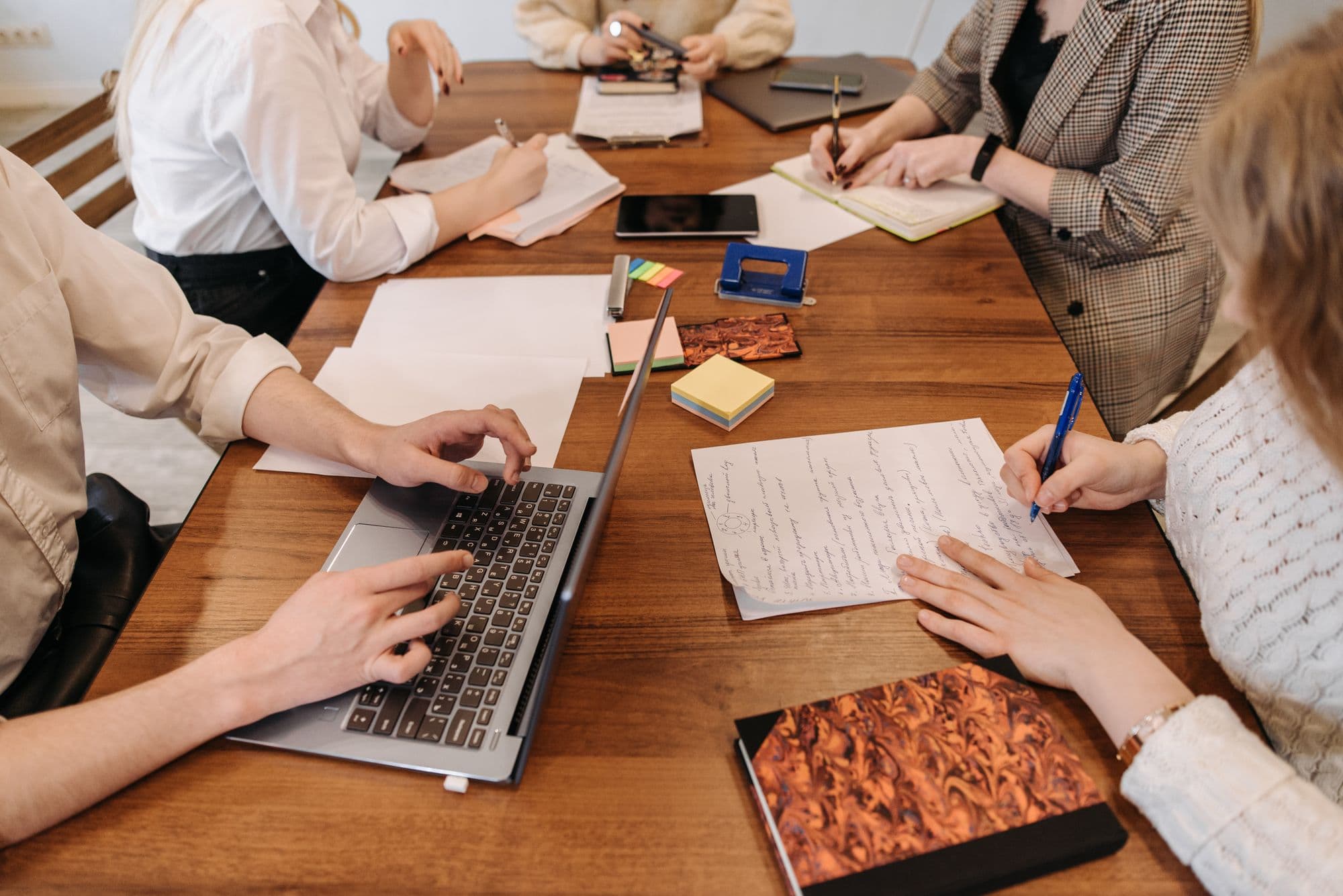 Illustrative stock photograph of professionals working with a laptop and documents