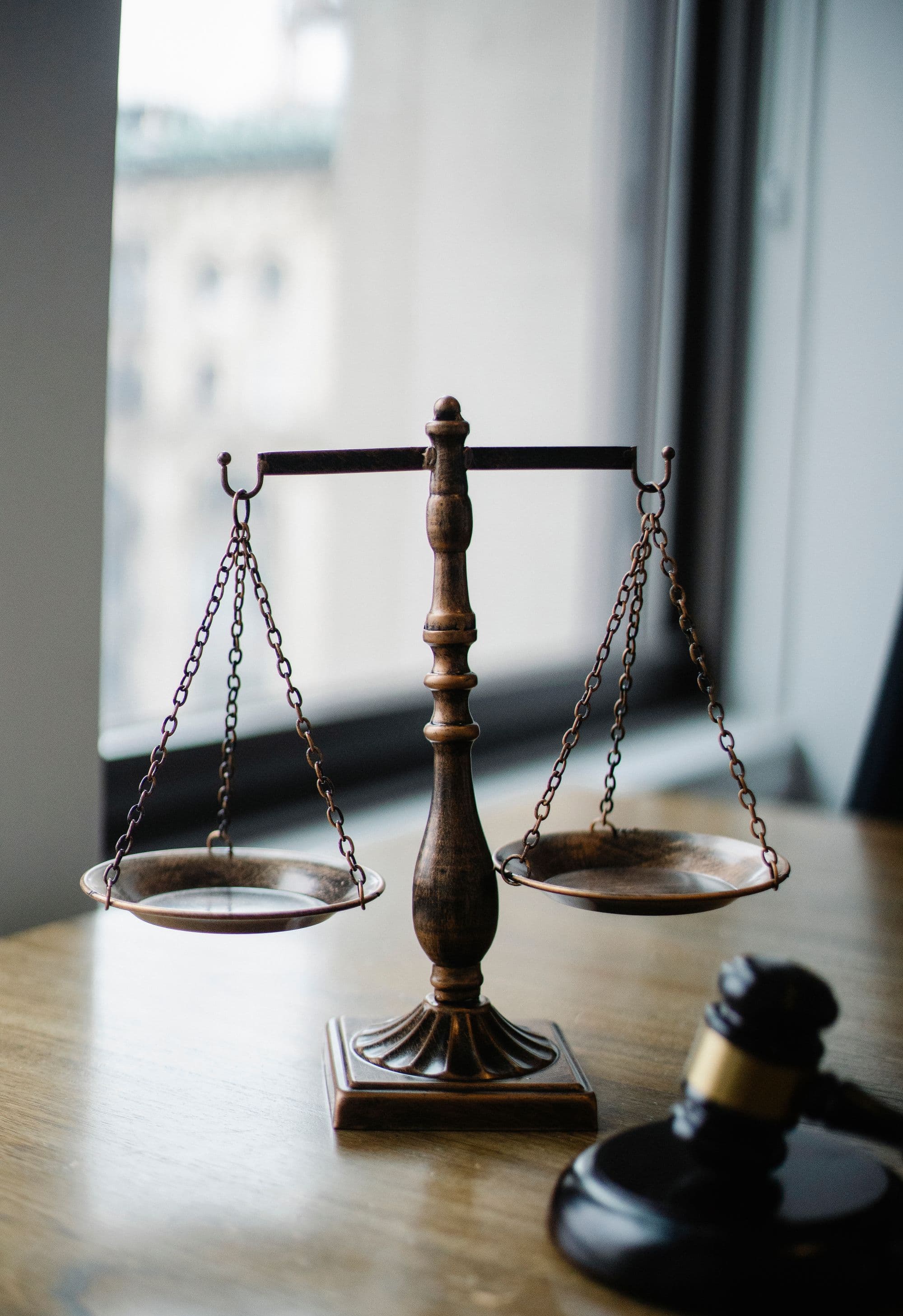 Illustrative stock photograph of the scales of justice on a desk